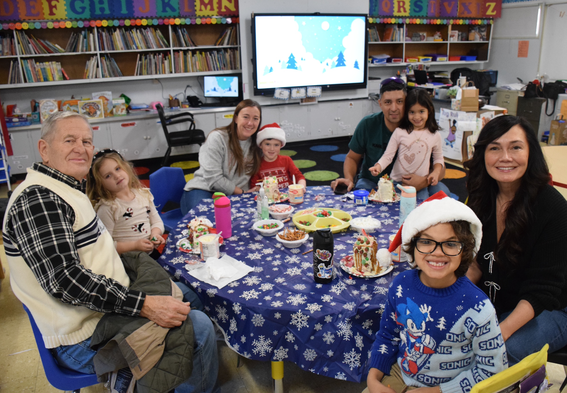 kids and parents sitting at a table smiling